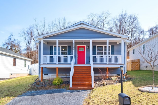 view of front of house featuring stairway, crawl space, covered porch, fence, and a front yard