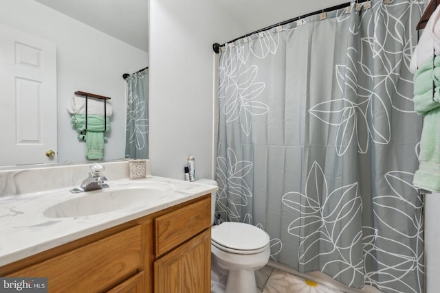 bathroom featuring toilet, curtained shower, tile patterned flooring, and vanity