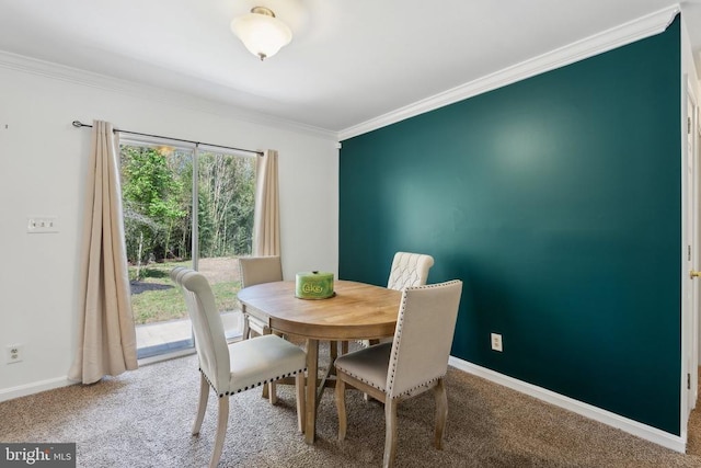 dining room featuring baseboards, ornamental molding, and carpet