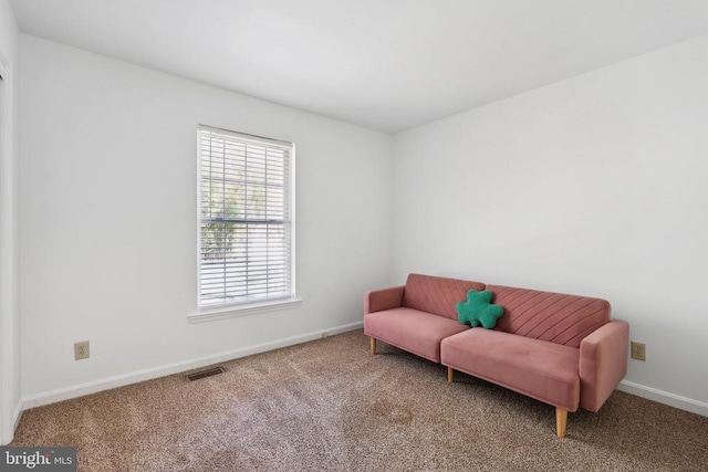 living area with baseboards, carpet flooring, and visible vents