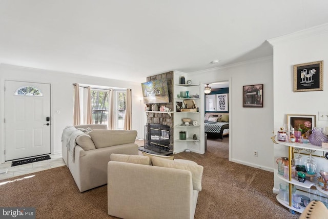 living room featuring crown molding, carpet, a ceiling fan, and a stone fireplace