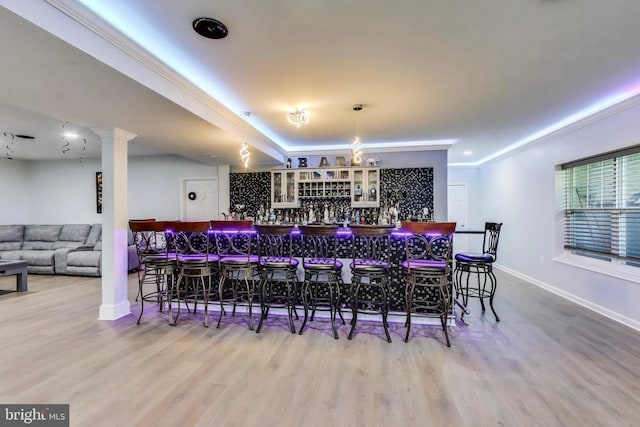 13001 Wipple Ct, Fredericksburg, VA 22407 - indoor dry bar featuring wood finished floors, crown molding, and decorative columns
