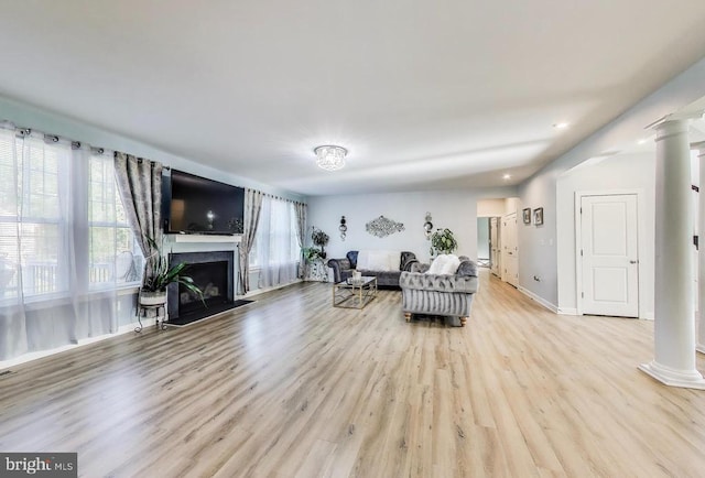 13001 Wipple Ct, Fredericksburg, VA 22407 - living area featuring decorative columns, wood finished floors, a fireplace with raised hearth, and recessed lighting