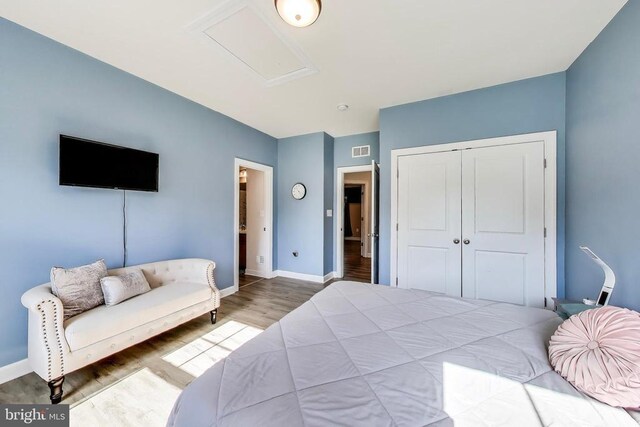 13001 Wipple Ct, Fredericksburg, VA 22407 - bedroom with wood finished floors, a closet, and attic access