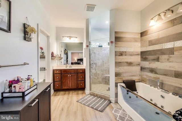 13001 Wipple Ct, Fredericksburg, VA 22407 - full bath featuring vanity, a shower stall, a tub with jets, and wood finished floors