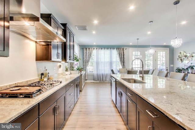 13001 Wipple Ct, Fredericksburg, VA 22407 - kitchen with wall chimney exhaust hood, appliances with stainless steel finishes, light wood finished floors, recessed lighting, and light stone countertops
