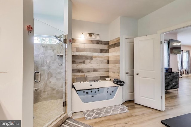 13001 Wipple Ct, Fredericksburg, VA 22407 - bathroom featuring a tub with jets, a shower stall, wood finished floors, and healthy amount of natural light