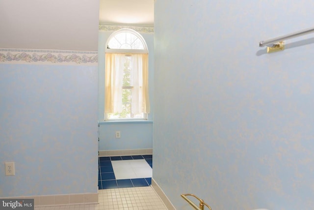bathroom with baseboards and tile patterned floors