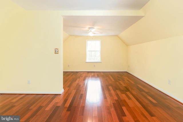additional living space featuring baseboards, wood finished floors, a ceiling fan, and lofted ceiling