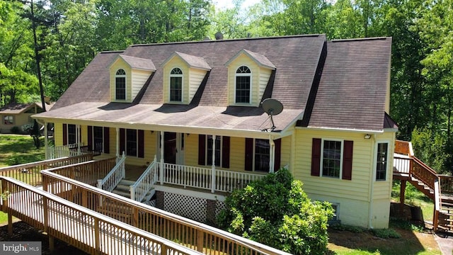 view of front of house featuring covered porch and stairs