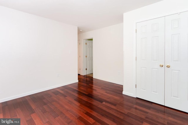 unfurnished bedroom featuring baseboards and wood finished floors