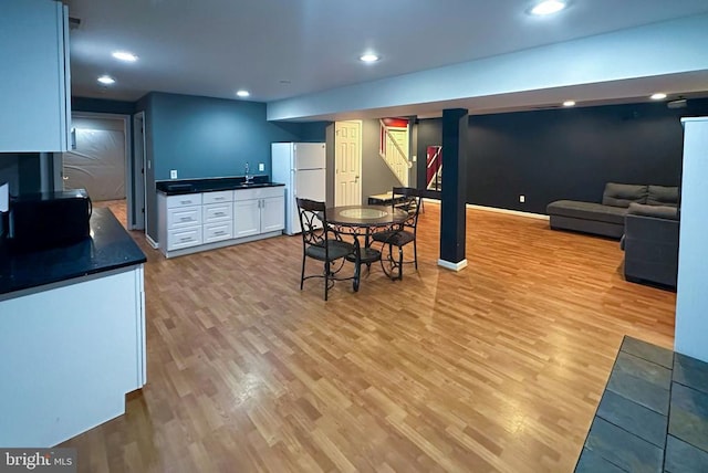 12107 Knight Ct, Fredericksburg, VA 22407 - kitchen with freestanding refrigerator, dark countertops, light wood-style floors, white cabinetry, and recessed lighting
