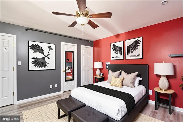12107 Knight Ct, Fredericksburg, VA 22407 - bedroom with wood finished floors, baseboards, a ceiling fan, and multiple closets