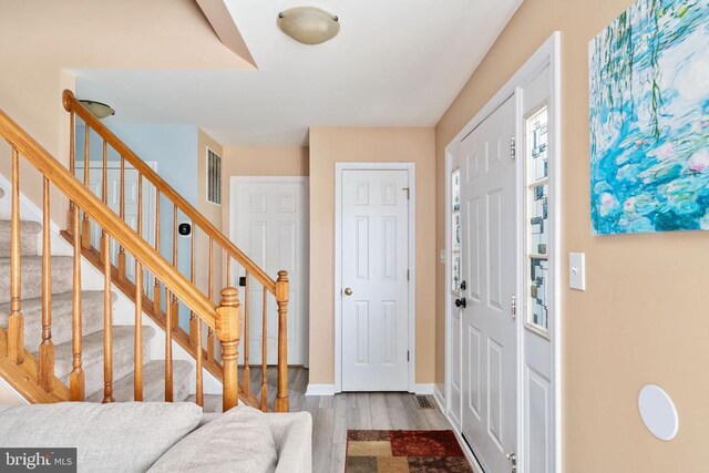 12107 Knight Ct, Fredericksburg, VA 22407 - foyer entrance featuring wood finished floors, stairs, and baseboards
