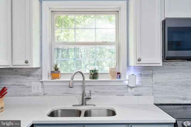 12107 Knight Ct, Fredericksburg, VA 22407 - kitchen with a sink, white cabinetry, and light stone counters