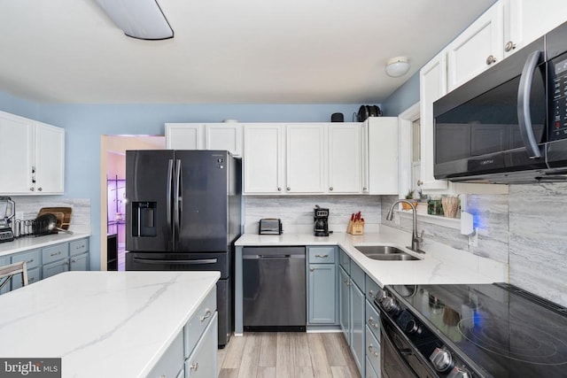 12107 Knight Ct, Fredericksburg, VA 22407 - kitchen featuring black appliances, a sink, backsplash, and white cabinetry