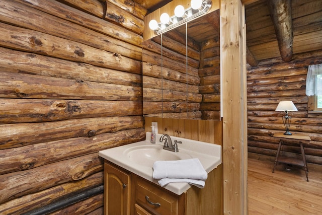 35 Bottom Rd S, Raphine, VA 24472 - bathroom with vanity, log walls, and wood finished floors