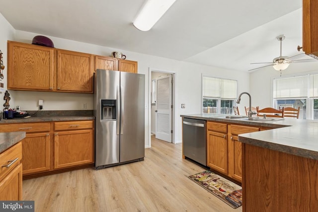 12224 Stonehenge Dr, Fredericksburg, VA 22407 - kitchen featuring appliances with stainless steel finishes, a sink, light wood-style floors, dark countertops, and a ceiling fan