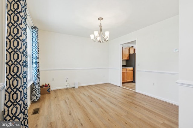 12224 Stonehenge Dr, Fredericksburg, VA 22407 - unfurnished room with a chandelier, light wood-type flooring, and baseboards