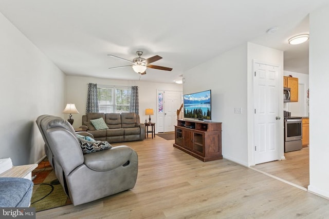 12224 Stonehenge Dr, Fredericksburg, VA 22407 - living room with light wood-style flooring, a ceiling fan, and baseboards