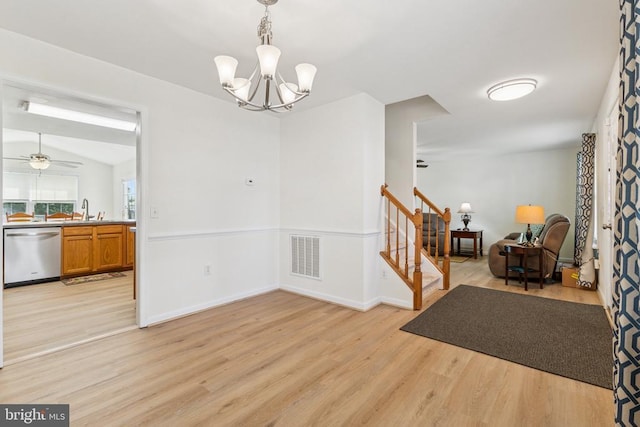 12224 Stonehenge Dr, Fredericksburg, VA 22407 - dining area with light wood-style flooring, stairway, ceiling fan, a chandelier, and baseboards
