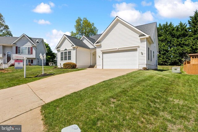 view of front facade featuring concrete driveway, a front lawn, and a garage