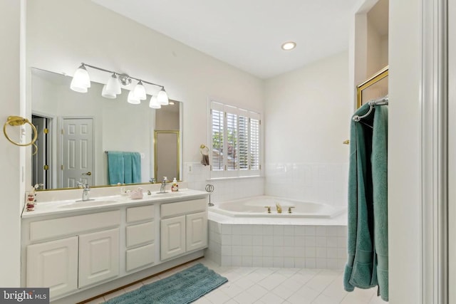 full bath with double vanity, a sink, tile patterned floors, a bath, and a shower stall