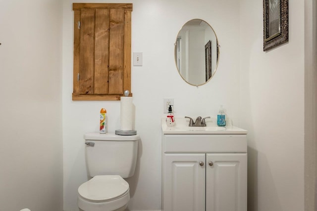 half bath featuring toilet and vanity
