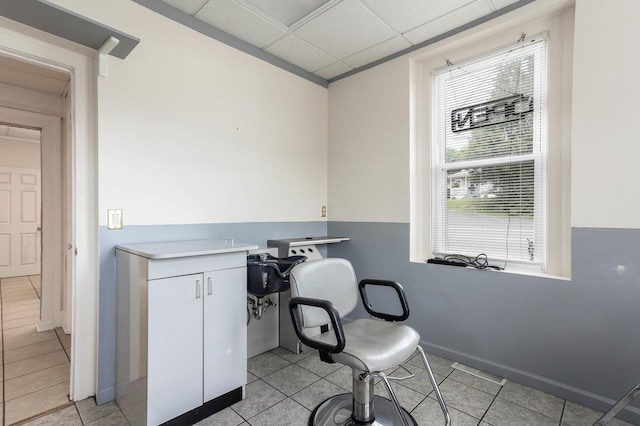 office area with baseboards, visible vents, and light tile patterned flooring