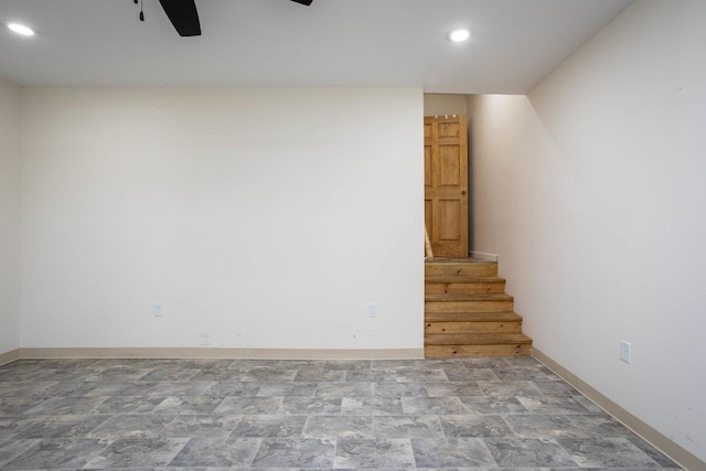 basement featuring recessed lighting, baseboards, stone finish flooring, ceiling fan, and stairway