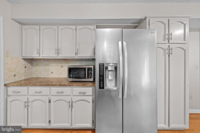 47 Marwood Dr, Palmyra, VA 22963 - kitchen featuring stainless steel appliances, tasteful backsplash, white cabinets, light wood-style flooring, and light stone countertops