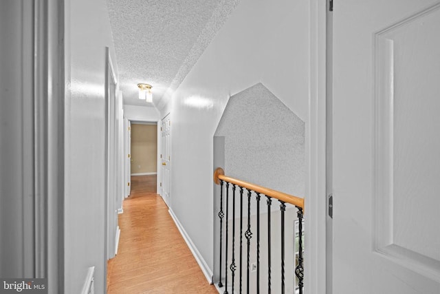 47 Marwood Dr, Palmyra, VA 22963 - hallway featuring a textured ceiling, light wood-type flooring, and an upstairs landing