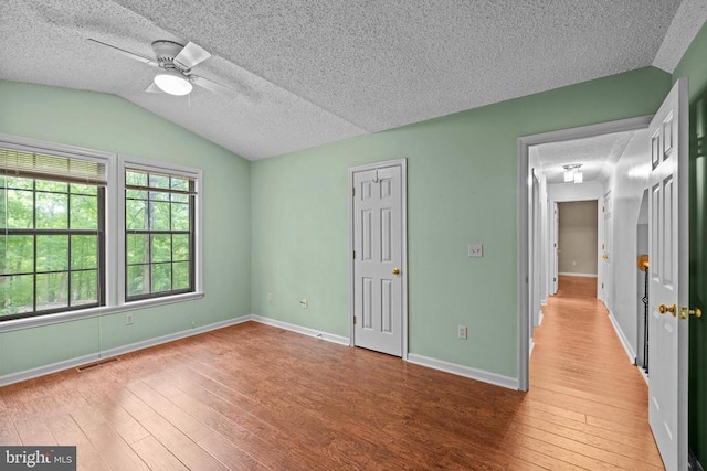 47 Marwood Dr, Palmyra, VA 22963 - unfurnished bedroom with a textured ceiling, hardwood / wood-style flooring, lofted ceiling, and a ceiling fan