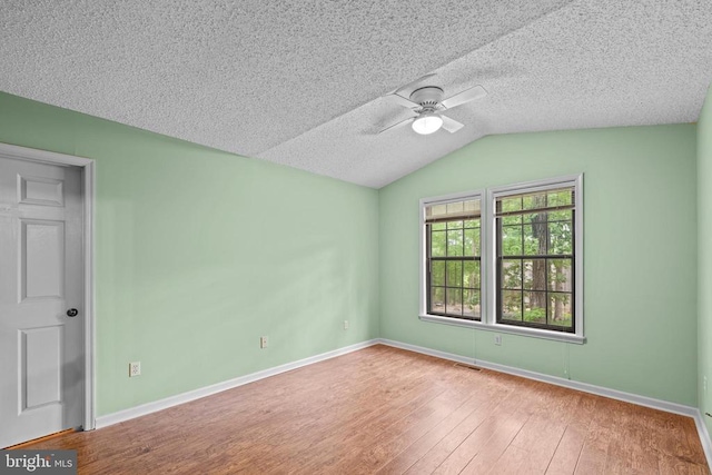 47 Marwood Dr, Palmyra, VA 22963 - spare room with ceiling fan, hardwood / wood-style floors, vaulted ceiling, and a textured ceiling