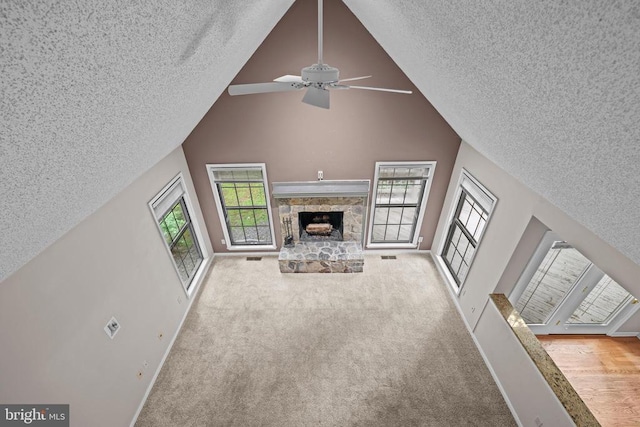 47 Marwood Dr, Palmyra, VA 22963 - unfurnished living room with a textured ceiling, a fireplace, a ceiling fan, carpet floors, and high vaulted ceiling
