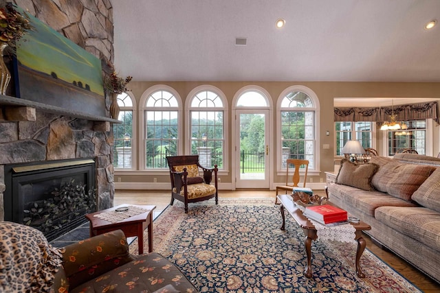 5090 Springhouse Cir, Rockingham, VA 22802 - living room featuring a wealth of natural light, a stone fireplace, and wood finished floors