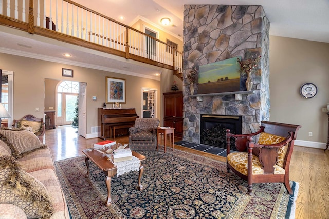 5090 Springhouse Cir, Rockingham, VA 22802 - living area with wood finished floors, a high ceiling, a fireplace, crown molding, and baseboards