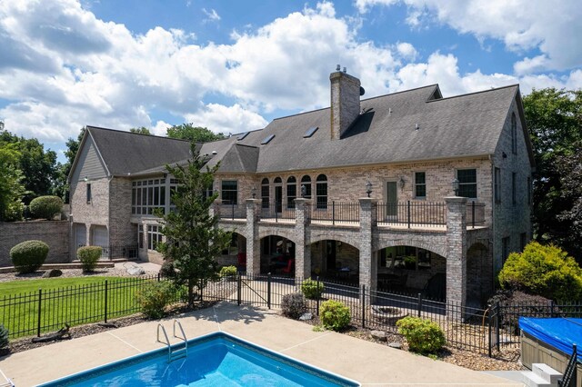5090 Springhouse Cir, Rockingham, VA 22802 - rear view of property with a chimney, a balcony, a fenced in pool, fence, and a patio area