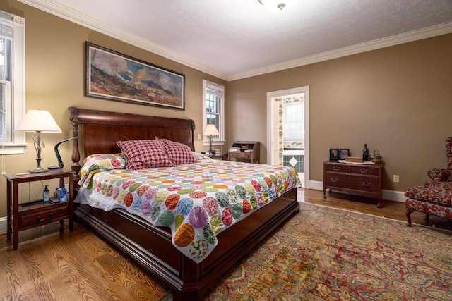 5090 Springhouse Cir, Rockingham, VA 22802 - bedroom with baseboards, ornamental molding, a textured ceiling, and wood finished floors