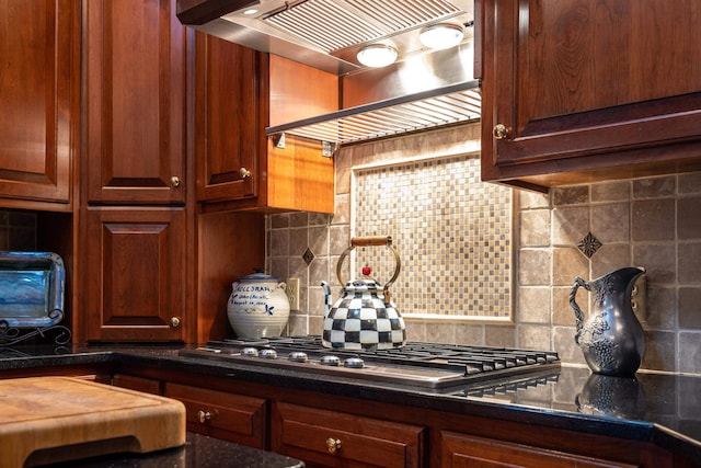 5090 Springhouse Cir, Rockingham, VA 22802 - kitchen featuring dark countertops, tasteful backsplash, under cabinet range hood, and stainless steel gas cooktop