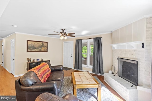 1905 Artillery Ridge Rd, Fredericksburg, VA 22408 - living area featuring wood finished floors, ornamental molding, ceiling fan, a fireplace, and baseboards