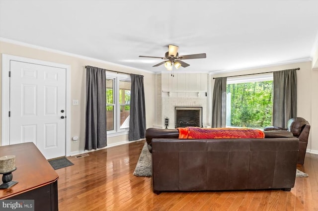 1905 Artillery Ridge Rd, Fredericksburg, VA 22408 - living room with hardwood / wood-style flooring, a brick fireplace, ceiling fan, ornamental molding, and baseboards