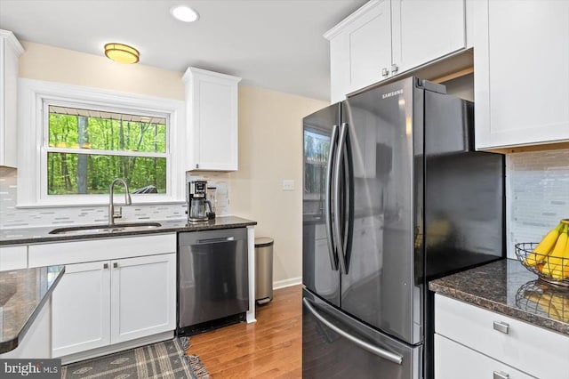 1905 Artillery Ridge Rd, Fredericksburg, VA 22408 - kitchen featuring freestanding refrigerator, a sink, dishwasher, light wood-style flooring, and white cabinetry