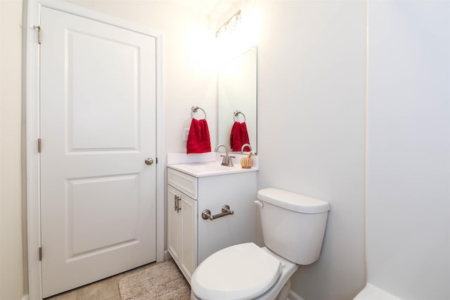 bathroom with tile patterned floors, vanity, and toilet