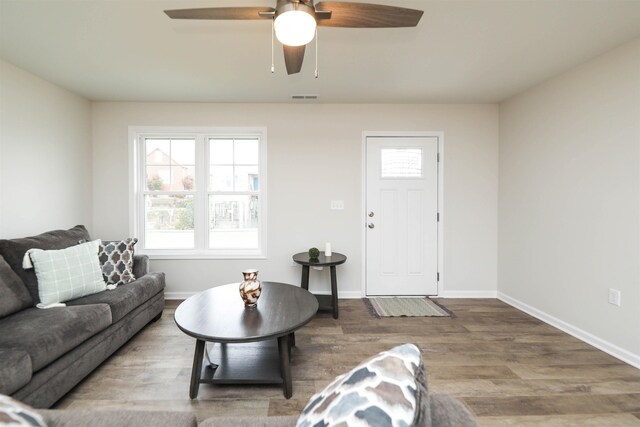 living room with ceiling fan, a healthy amount of sunlight, and wood-type flooring