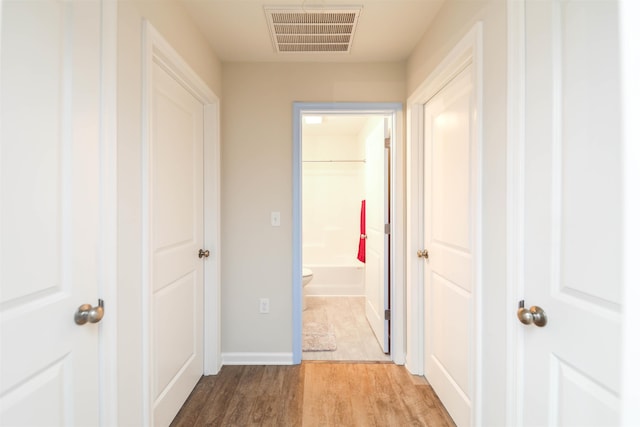 hall with light hardwood / wood-style flooring