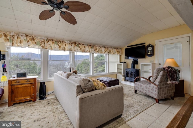 145 Colwood Dr, Rileyville, VA 22650 - living room with a wood stove, ceiling fan, light tile patterned flooring, and vaulted ceiling