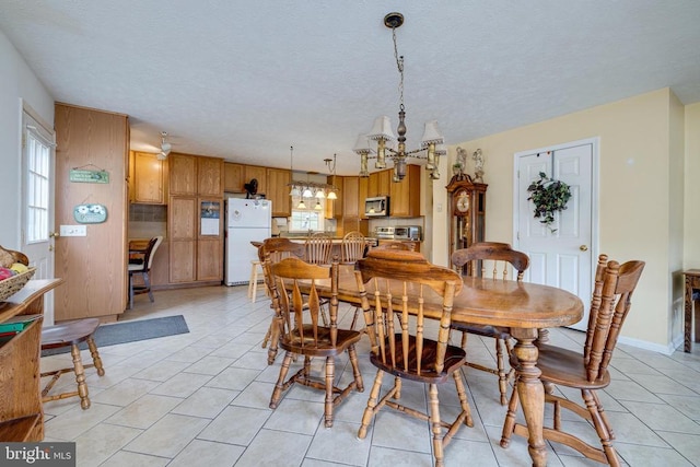 145 Colwood Dr, Rileyville, VA 22650 - dining area featuring an inviting chandelier, a textured ceiling, and light tile patterned floors