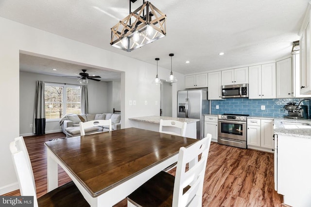  - dining area with dark wood-type flooring, a ceiling fan, and recessed lighting