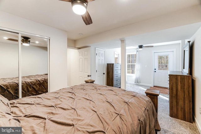  - carpeted bedroom with a ceiling fan and a closet